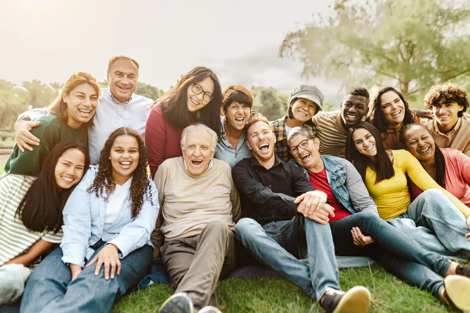 Family relaxing together on the grass in a park